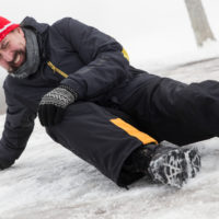 Man slips on icey street Man slips on icey street