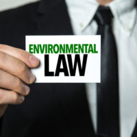 Man holding Environmental law sign