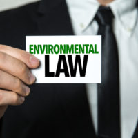 Man holding Environmental law sign Man holding Environmental law sign