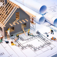 house being built on a written printout house being built on a written printout