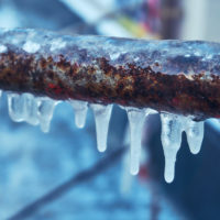 Many small icicles around freezing pipes Many small icicles around freezing pipes