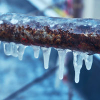 Many small icicles around freezing pipes