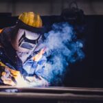 Worker welding in a factory.