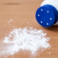 Talcum powder on wooden background