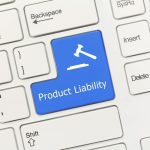 Close-up view on white conceptual keyboard - Product Liability (blue key)