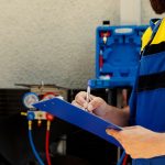 Hvac worker fills out warranty contract