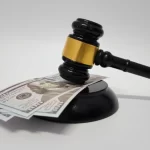 Judicial Gavel on Stack of Dollar Banknotes for Corruption and Legal Cost Concept